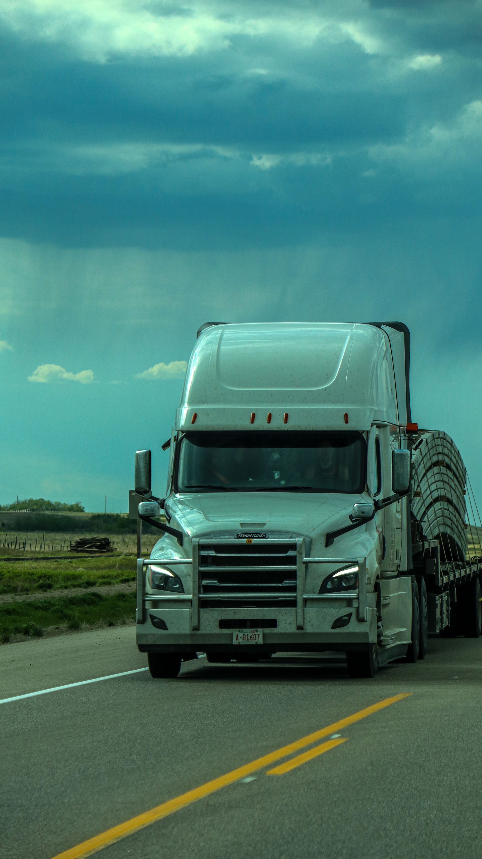 Semi-truck flatbed under a dramatic sky